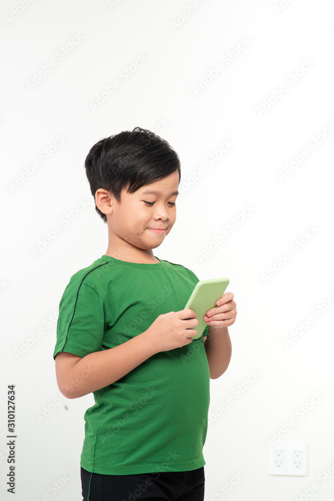Asian boy using mobile phone on white background Asian boy using mobile phone on white background