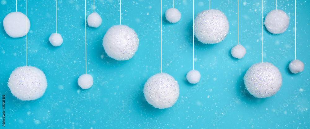 Christmas composition. The concept of a winter festive background, snowfall from white balls on a blue background. Christmas, winter, new year concept. Banner Minimalism flat lay - obrazy, fototapety, plakaty 