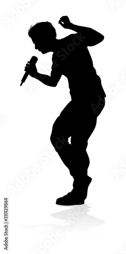 A singer pop, country music, rock star or hiphop rapper artist vocalist singing in silhouette