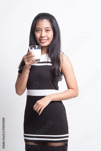 Healthy Asian woman drinking a glass of milk