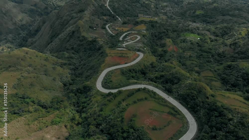 Aerial view of winding roads with high mountains on side on rural area Aerial view of winding roads with high mountains on side on rural area