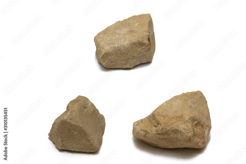 Three beige pebbles on a white background
