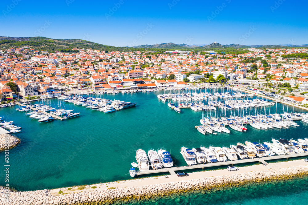 Yachting marina in town of Vodice and amazing turquoise coastline on Adriatic coast, aerial view, Croatia