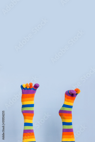 Legs in funny socks on blue backgroundt photo