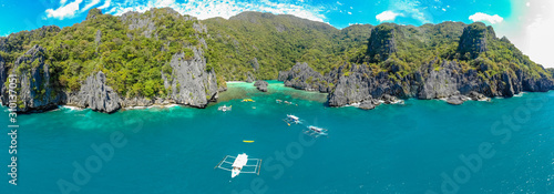 Fototapeta Naklejka Na Ścianę i Meble -  Aerial view of Ubugon Cove on paradise Cadlao island with sharp limestone rocks, tropical travel destination - El Nido, Palawan, Philippines.