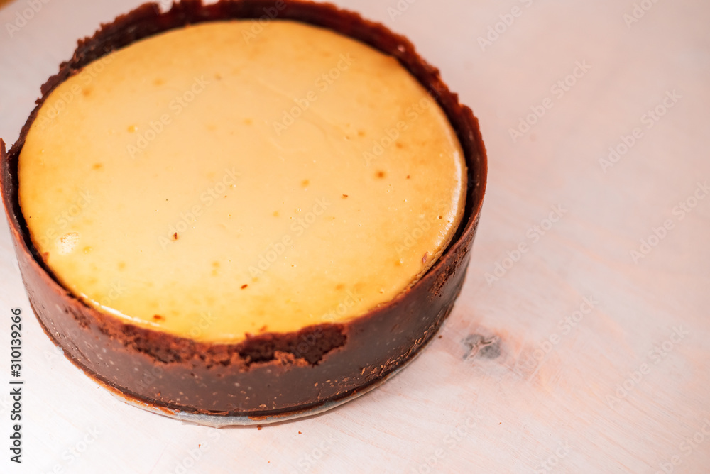 whole, freshly baked cheesecake on a neutral background whole, freshly baked cheesecake on a neutral background