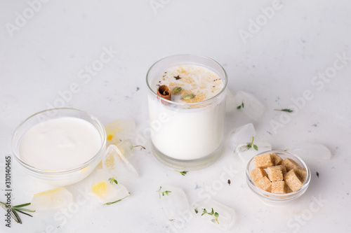 lassi next to the ingredients on a white background