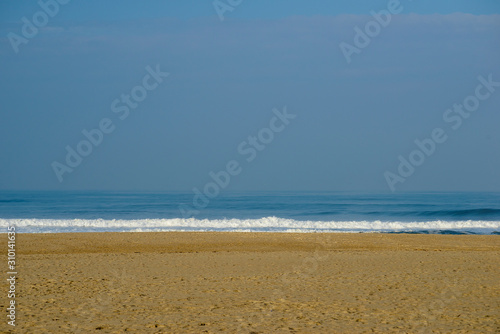 Portugal beach background with sand and blue sky in the Atlantic ocean