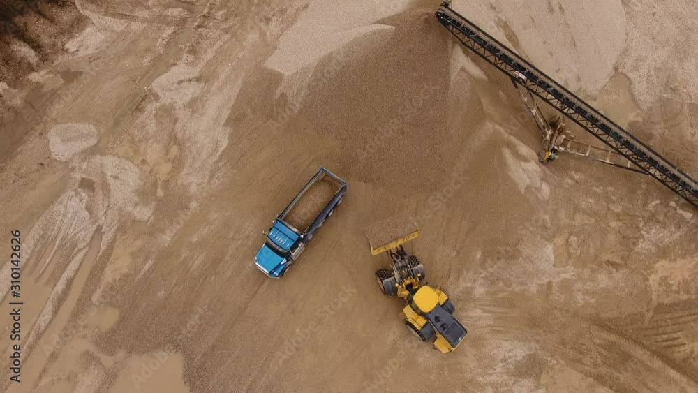 Bulldozer Placing Rock in Truck (Drone View) Bulldozer Placing Rock in Truck (Drone View)