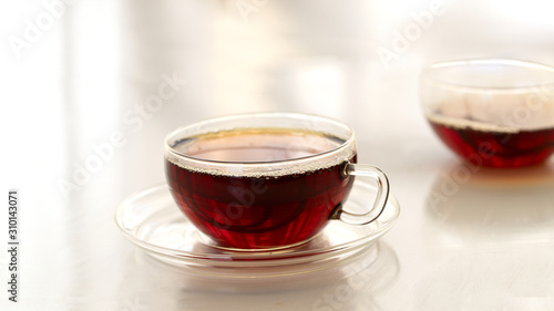 Glass of black tea on white background. Hot drink concept.
