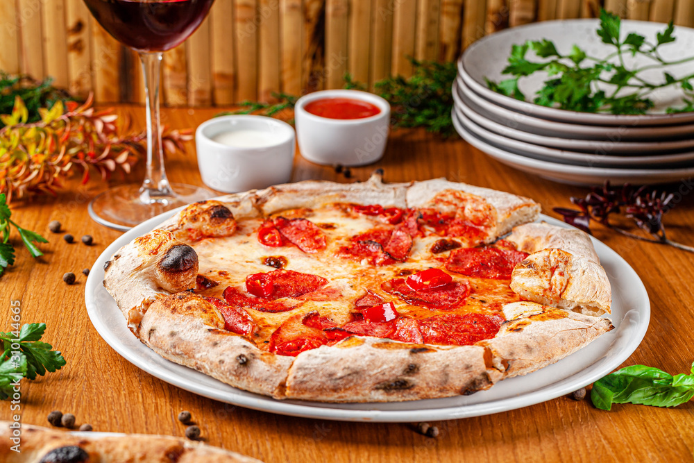 Italian food concept. Thin pizza with thick sides on a white plate. background image. copy space