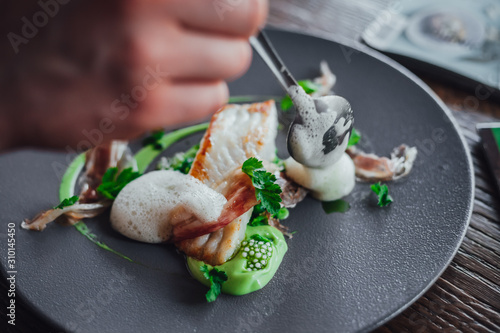 Fish food on plate  in michelin star restaurant photo