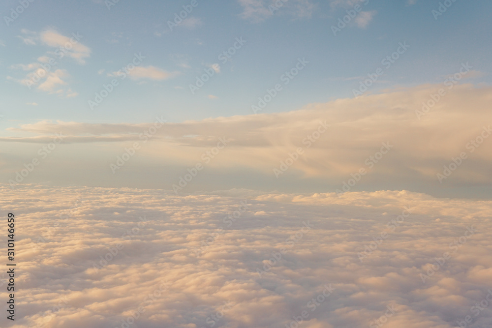 Obraz premium Sky with clouds at sunset from inside the plane landscape
