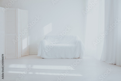 the Interior of the white room with sofa and window