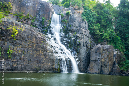  Amazing Pongour waterfall in Vietnam  Da Lat with the Buddha on the top.Travel concept  wonderful view for crystal clear falling water in the rainforest. Beautiful nature wallper.