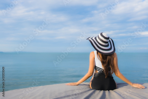 Portrait beautiful young asian women relax smile happy around sea beach ocean