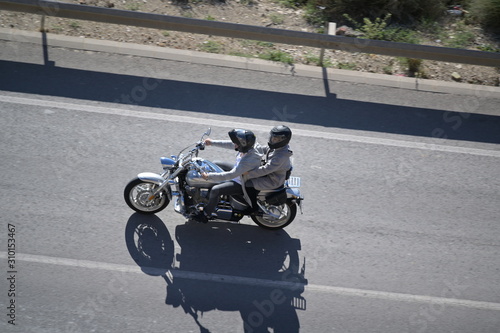 Bird view of a couple on an motorcycle in Finestrat-Spain.
