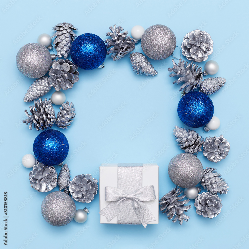 Flat lay of an empty red greeting card in the centre of the composition of bumps and white balls on the red background. Christmas concept Flat lay of an empty red greeting card in the centre of the composition of bumps and white balls on the red background. Christmas concept