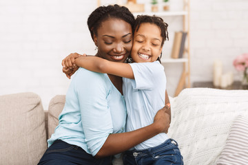 Smiling afro family celebrating mothers day at home
