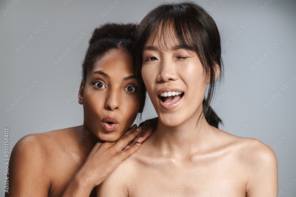 Portrait of two multinational women expressing surprise and winking Portrait of two multinational women expressing surprise and winking