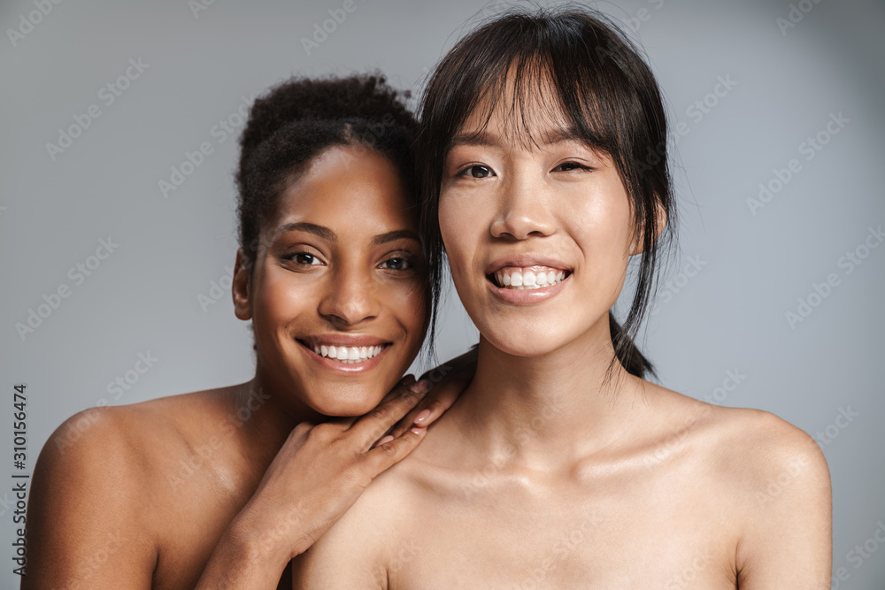 Portrait of two multinational women posing together and laughing Portrait of two multinational women posing together and laughing