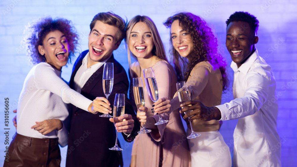 Joyful Friends Clinking Champagne Flutes Celebrating New Year Standing Indoor Joyful Friends Clinking Champagne Flutes Celebrating New Year Standing Indoor