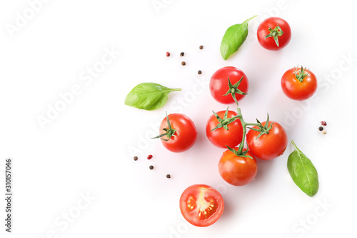 Ripe red cherry tomatos and basil on white background. Top view