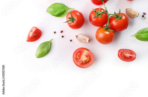 Ripe red cherry tomatos and basil isolated on white background. Top view