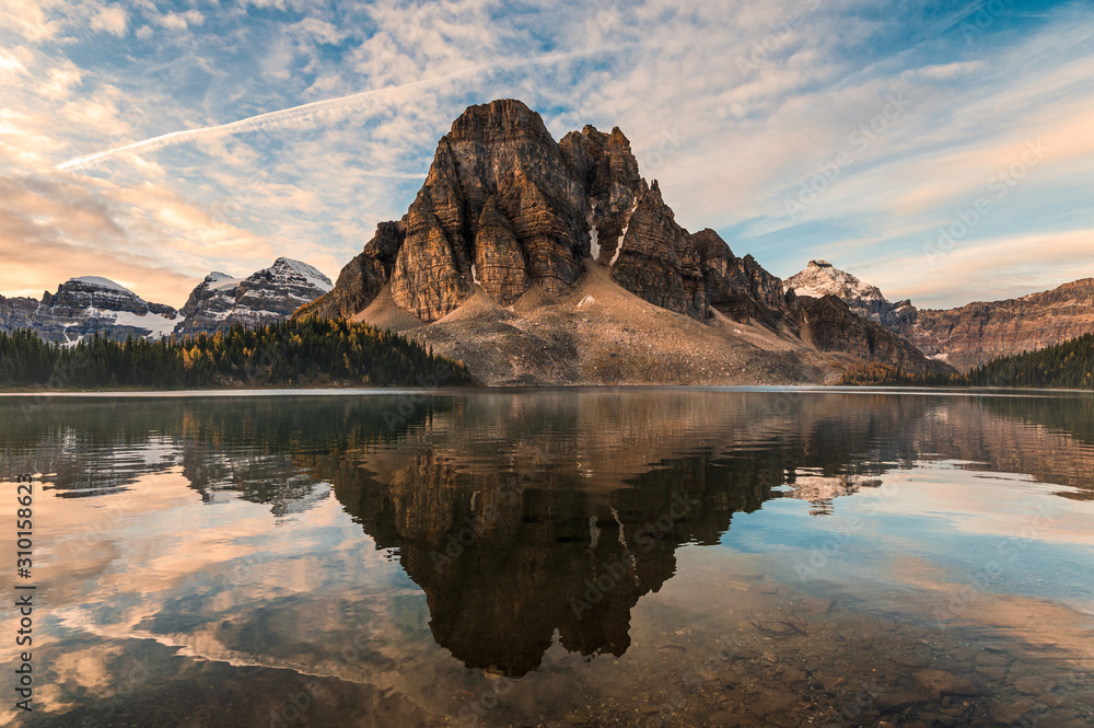 Fototapeta premium Rocky mountain reflection on Cerulean lake in Assiniboine provincial park