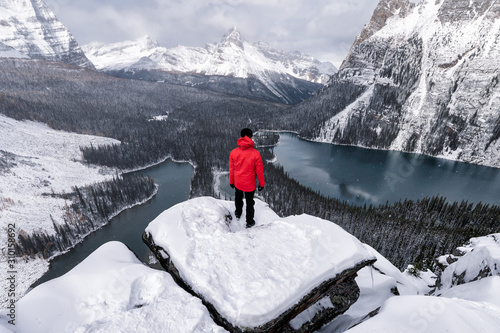 Traveler standing on rock over Opabin Plateau with lake O'hara in snowing at Yoho national park
