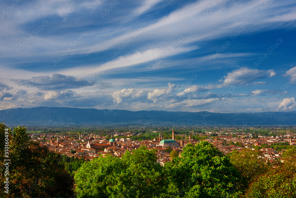 Panoramic view of Vicenza historic center with the famous renaissance Basilica Palladiana and nearby mountains with clouds, from Mount Berico terrace