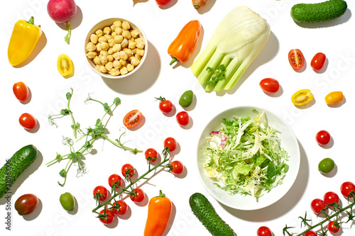 Photography Healthy salad ingredients on white background in hard sun light with harsh shadows