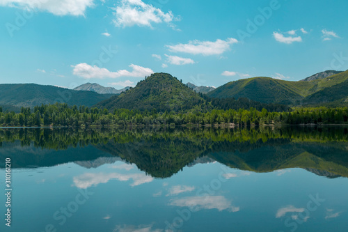 Reftection of blue sky and natural clouds over blue lake