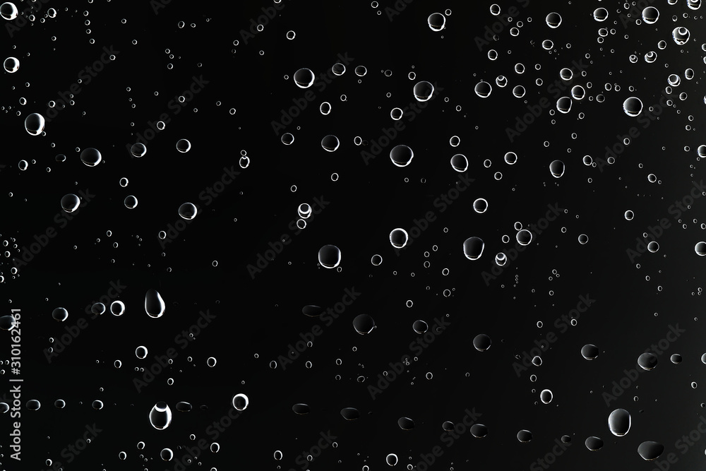black wet background / raindrops for overlaying on window, concept of autumn weather, background of drops of water rain on glass transparent