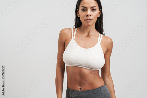 Image of fitness woman in sportswear standing and looking at camera