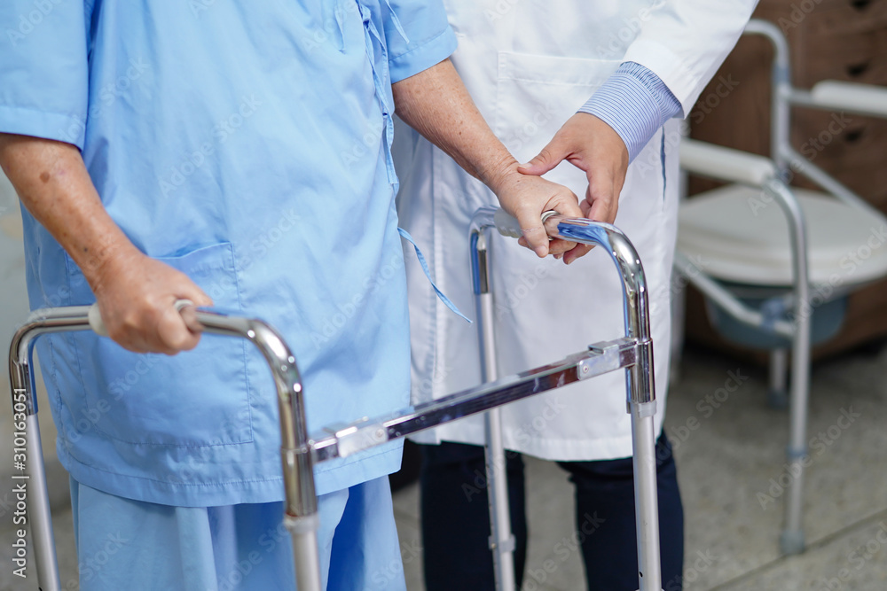 Doctor help Asian senior or elderly old lady woman patient walk with walker at nursing hospital ward : healthy strong medical concept . Doctor help Asian senior or elderly old lady woman patient walk with walker at nursing hospital ward : healthy strong medical concept .