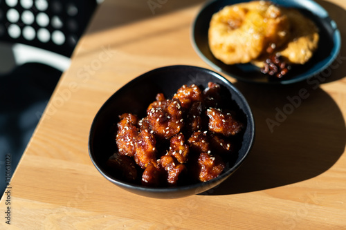 Asian Food Homemade Chinese General Tsos Chicken with Sesame Seeds served with Chopsticks. photo