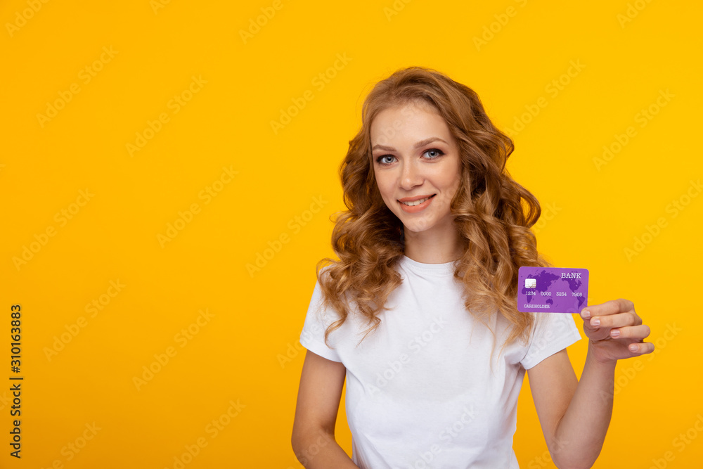 Shopping online concept. Young female with credit card in the studio Shopping online concept. Young female with credit card in the studio