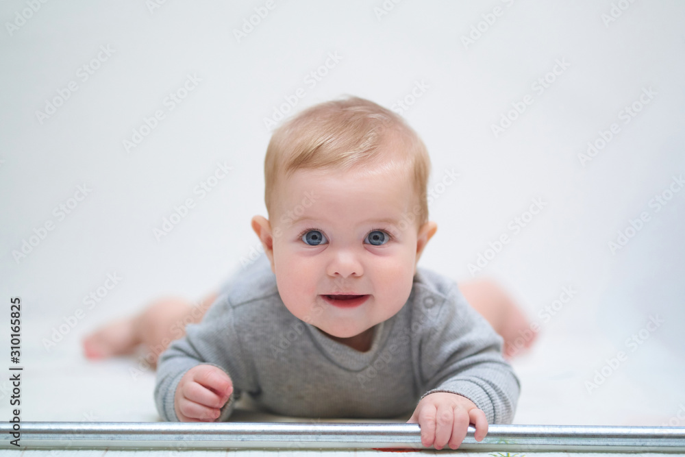 emotional portrait of a child. photo on a neutral background in gray clothes