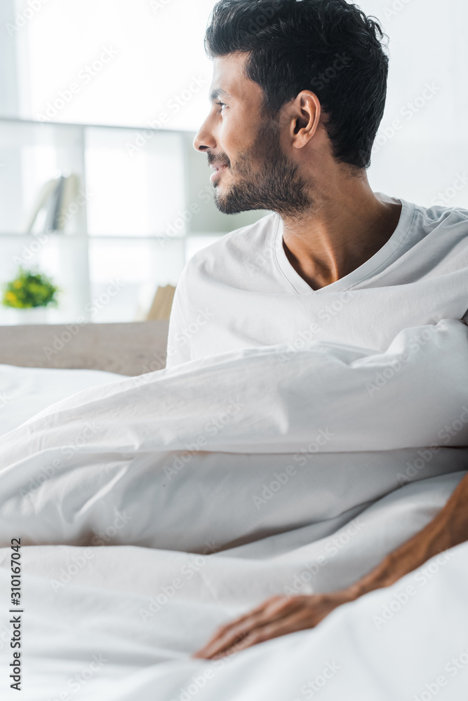 handsome and smiling bi-racial man looking away in morning handsome and smiling bi-racial man looking away in morning