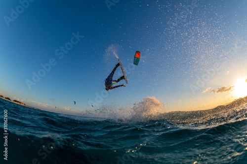 Person surfing and flying a parachute at the same time in Kitesurfing Bonaire, Caribbean