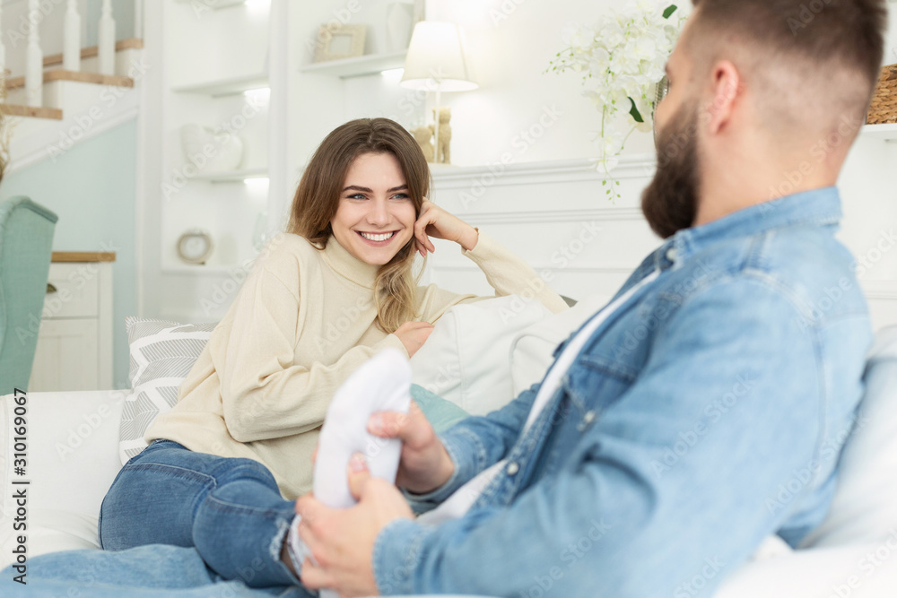 Caring husband giving foot massage to her wife Caring husband giving foot massage to her wife