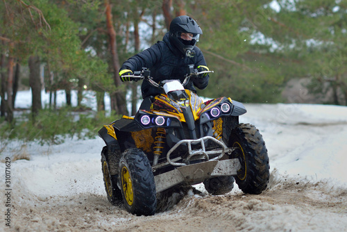 ATV and UTV driving in mud and snow at winter. ATV/UTV/4x4 off-road