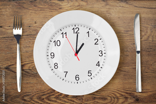 Knife, fork, white plate wi...