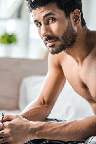 handsome and sexy bi-racial man looking at camera in morning