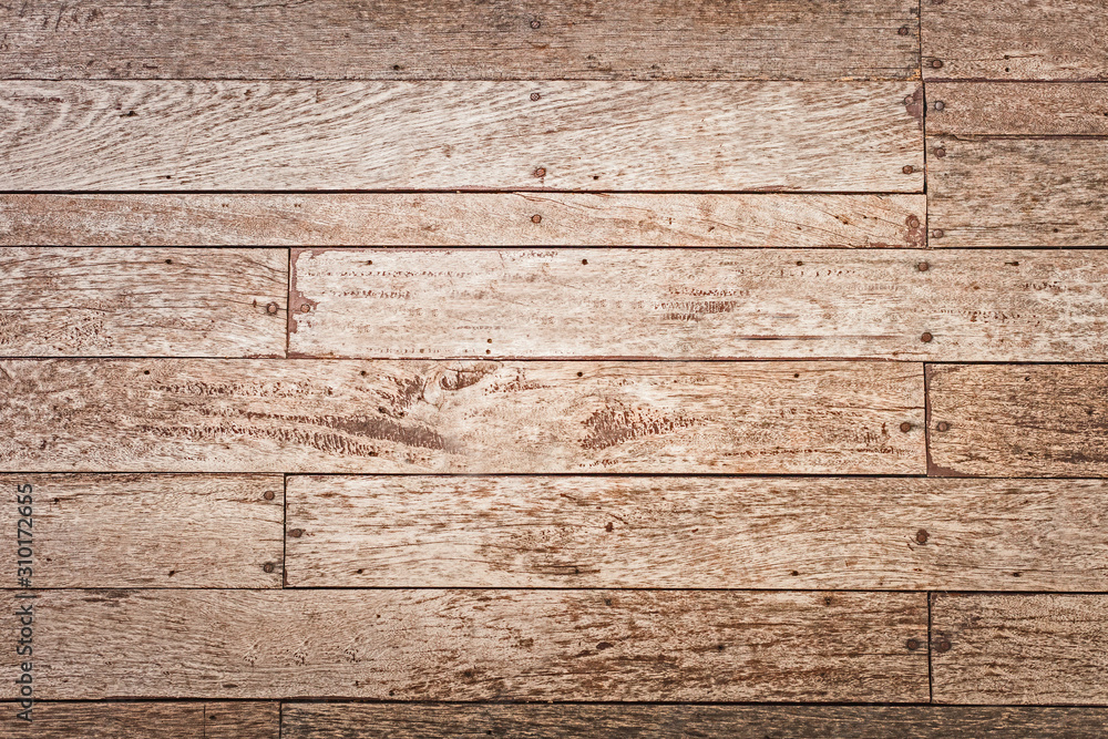 The front of the village house is covered with old brown boards.Texture or background The front of the village house is covered with old brown boards.Texture or background
