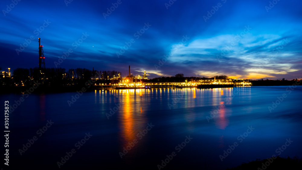 River rhine with oil refinery in the background, longtime shot near Cologne, Germany