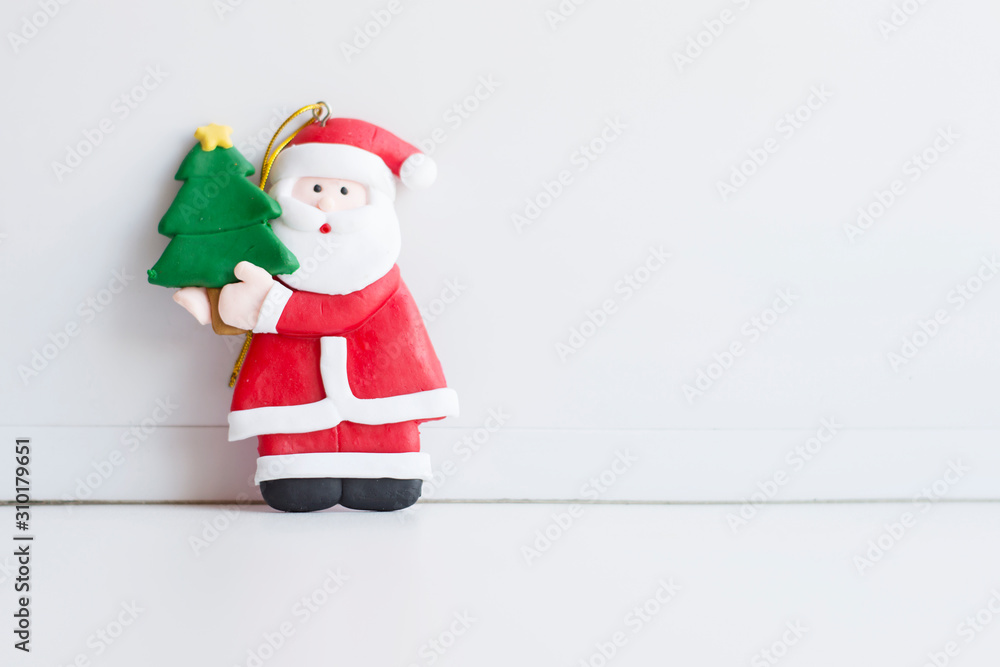 Santa Claus figurine with festive fir tree on white background Santa Claus figurine with festive fir tree on white background