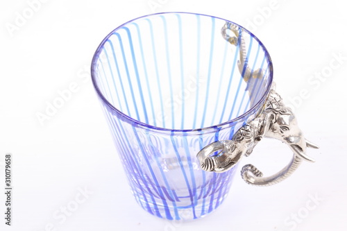 A blue glass cup of water on white background