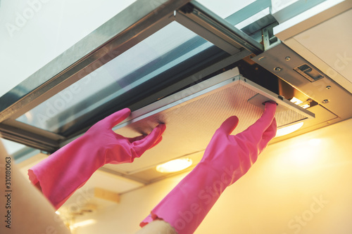 Foto removing dirty cooker hood filter for cleaning